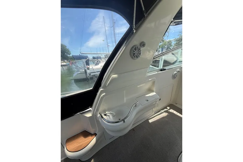 Slide: The Image of Interior view of a 1999 Sea Ray Sundancer 310 yacht, showcasing sleek design and marina backdrop. - 13