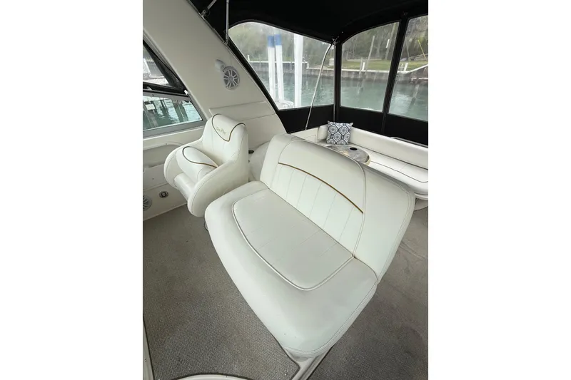 Slide: The Image of Interior of 1999 Sea Ray Sundancer 310 with white leather seating and scenic windows. - 14