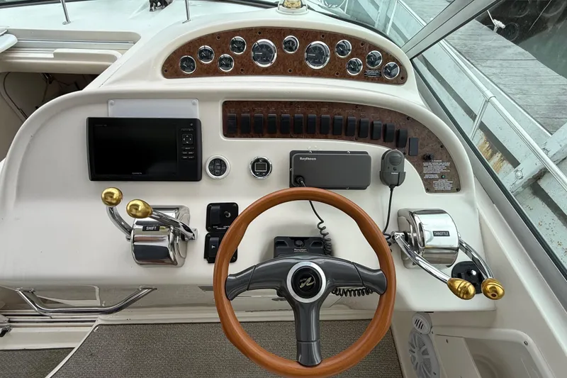 Slide: The Image of 1999 Sea Ray Sundancer 310 helm with gauges, controls, and navigation equipment. - 17