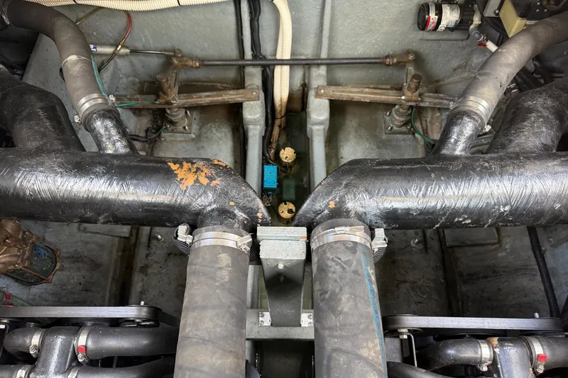 Slide: The Image of Engine compartment of a 1999 Sea Ray Sundancer 310 with visible hoses and components. - 29