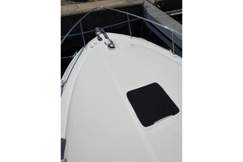 Slide: The Image of Bow view of 1999 Sea Ray Sundancer 310 yacht, featuring sleek deck design. - 6