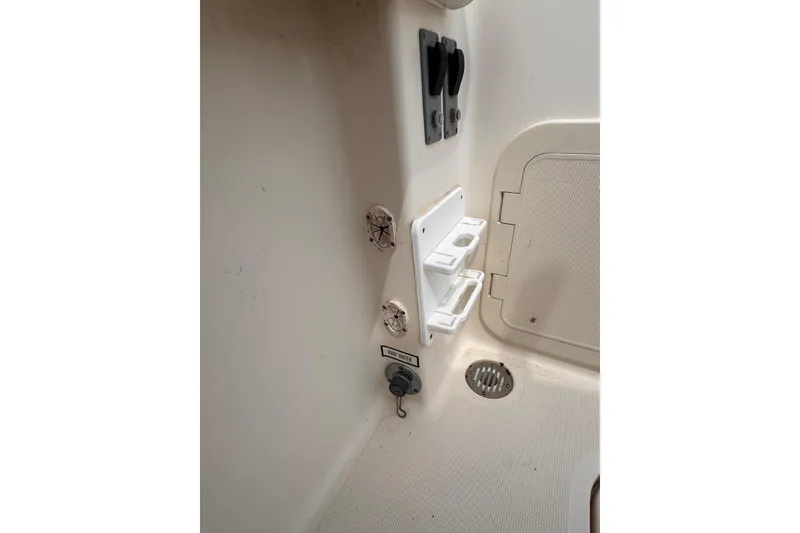 Slide: The Image of Interior view of a 2004 Pursuit 2670 Cuddy Console boat, featuring utility compartments. - 13