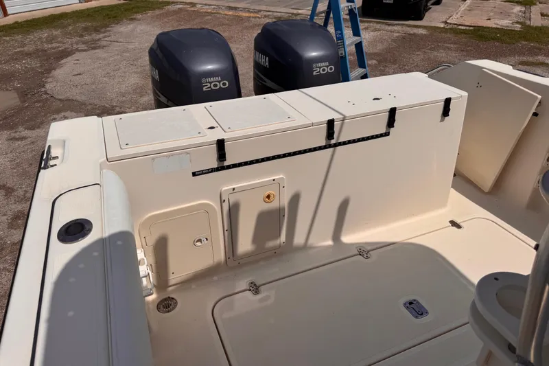 Slide: The Image of 2004 Pursuit 2670 Cuddy Console boat with Yamaha 200 engines, docked outdoors. - 16
