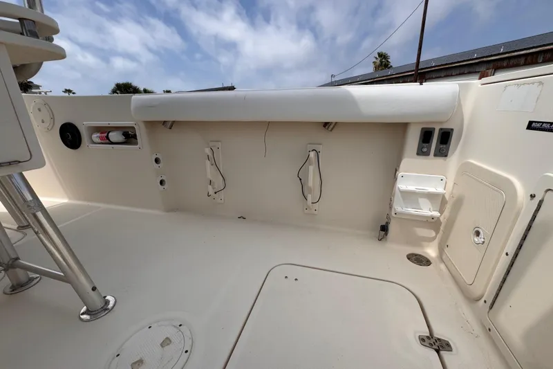 Slide: The Image of 2004 Pursuit 2670 Cuddy Console boat interior with storage compartments and seating. - 17