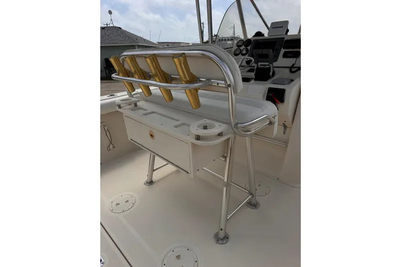 Slide: The Image of 2004 Pursuit 2670 Cuddy Console boat interior with rod holders and control panel. - 24