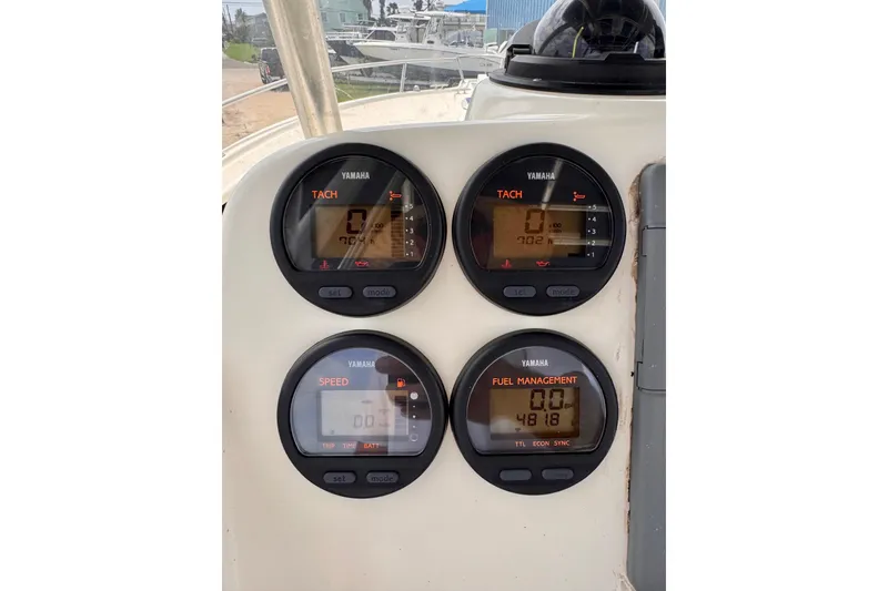 Slide: The Image of Yamaha gauges on 2004 Pursuit 2670 Cuddy Console boat dashboard, displaying tachometer and fuel management. - 29