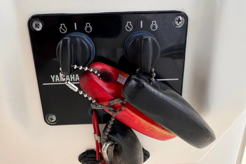 Slide: The Image of Yamaha ignition panel with keys on a 2004 Pursuit 2670 Cuddy Console boat. - 34