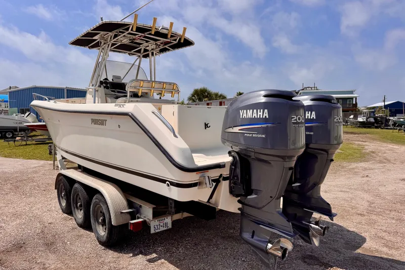 Slide: The Image of 2004 Pursuit 2670 Cuddy Console boat with twin Yamaha 200 engines on trailer. - 4