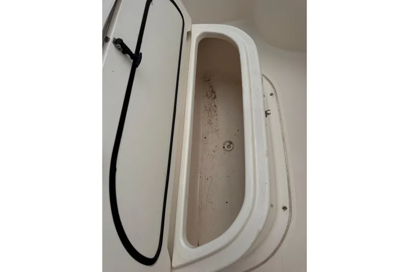 Slide: The Image of Open storage compartment on a 2004 Pursuit 2670 Cuddy Console boat. - 40