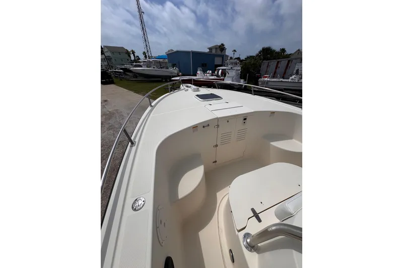 Slide: The Image of 2004 Pursuit 2670 Cuddy Console boat, docked with clear sky background. - 41