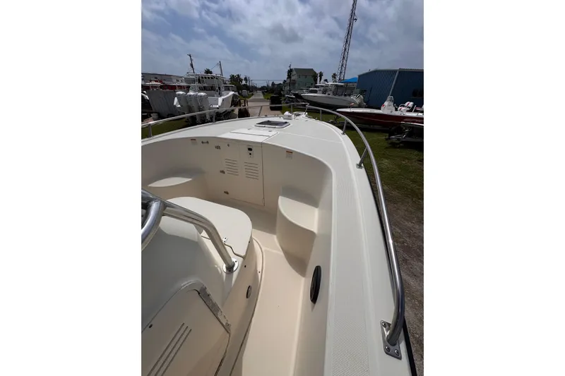 Slide: The Image of 2004 Pursuit 2670 Cuddy Console boat, docked outdoors under a cloudy sky. - 42