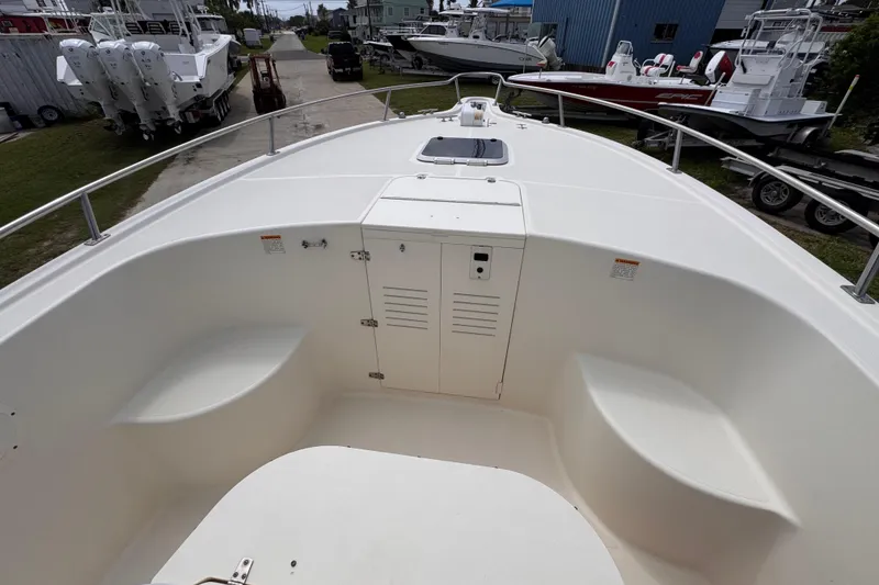 Slide: The Image of 2004 Pursuit 2670 Cuddy Console boat interior with seating and storage compartments. - 43