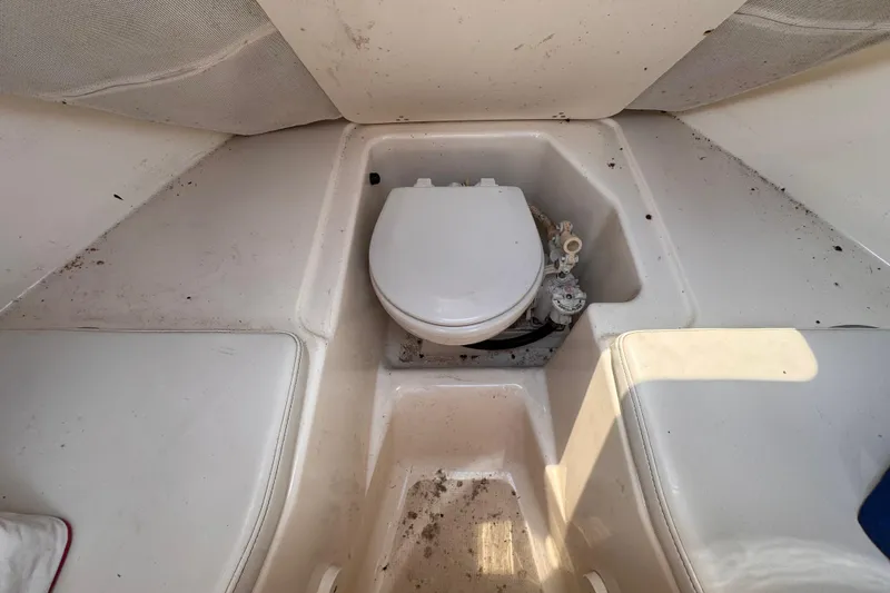 Slide: The Image of 2004 Pursuit 2670 Cuddy Console boat interior with toilet and seating area. - 46