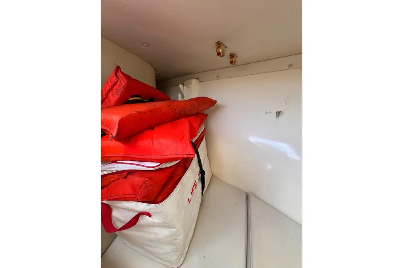 Slide: The Image of Storage area in 2004 Pursuit 2670 Cuddy Console with life jackets and safety gear. - 47