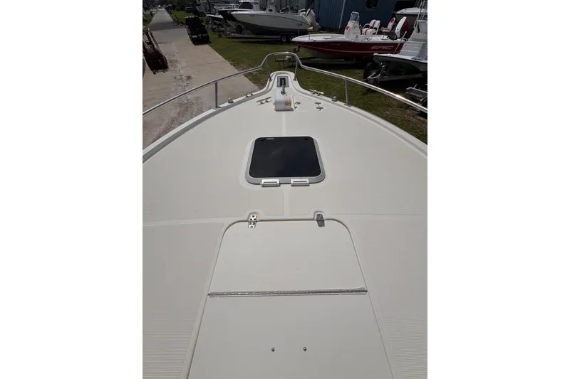 Slide: The Image of 2004 Pursuit 2670 Cuddy Console boat deck with hatch, docked outdoors. - 49