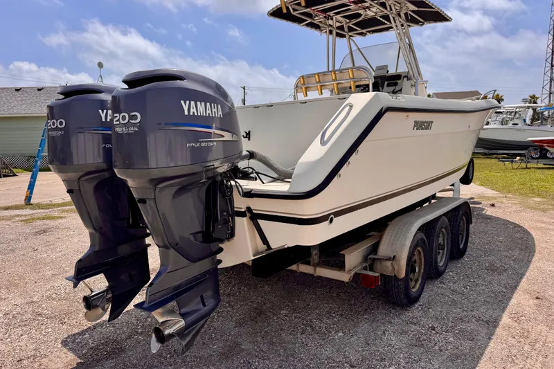 Slide: The Image of 2004 Pursuit 2670 Cuddy Console boat with twin Yamaha 200 engines on a trailer. - 5