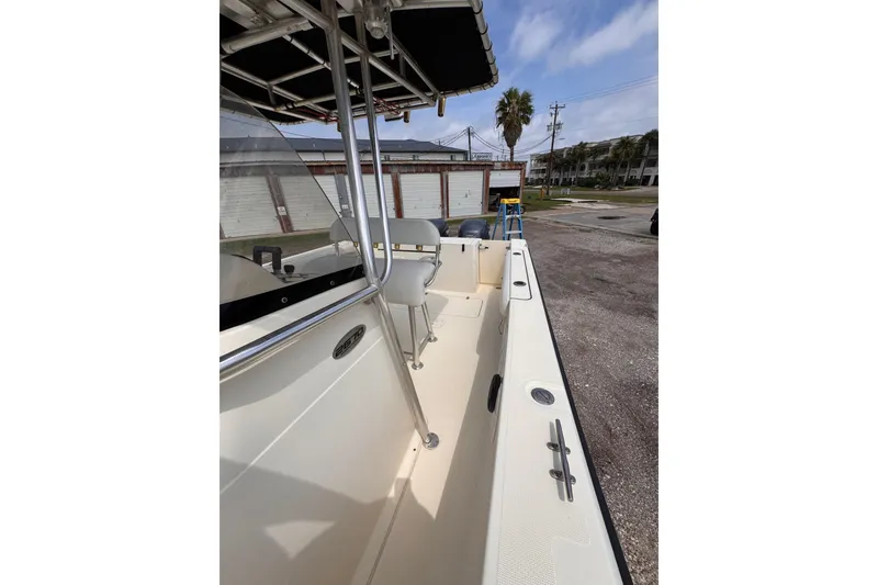 Slide: The Image of 2004 Pursuit 2670 Cuddy Console boat, side view, parked outdoors. - 53