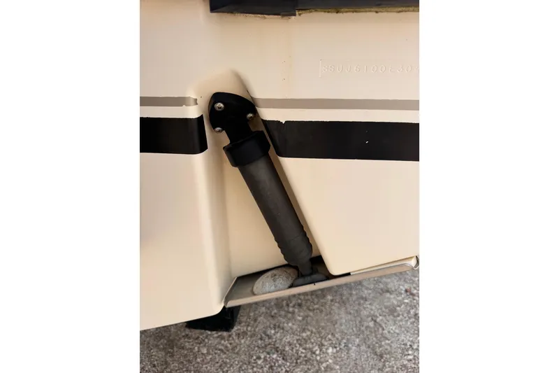 Slide: The Image of Close-up of a 2004 Pursuit 2670 Cuddy Console boat detail, showing a black rubber component. - 57