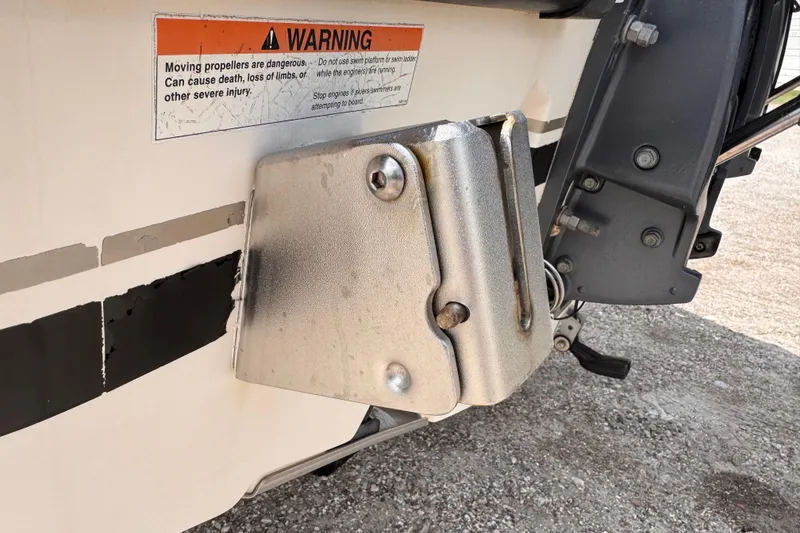 Slide: The Image of Close-up of a 2004 Pursuit 2670 Cuddy Console boat's stern with warning label. - 58