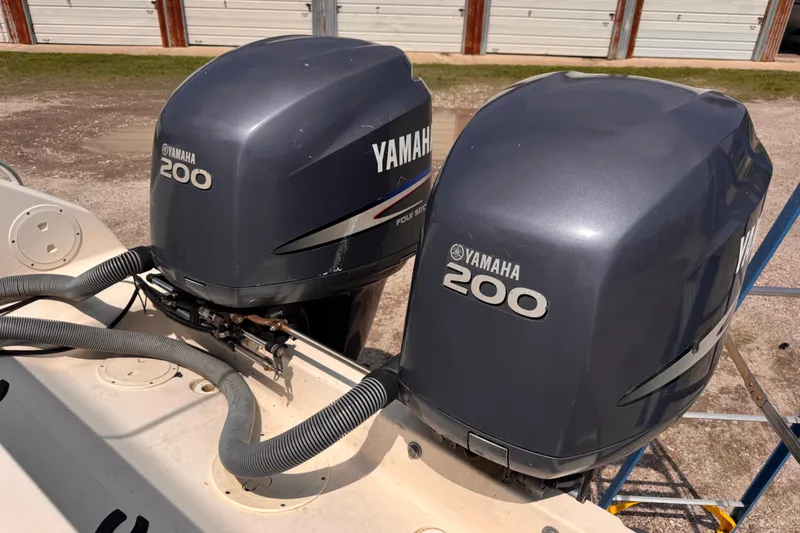 Slide: The Image of Twin Yamaha 200 outboard motors on a 2004 Pursuit 2670 Cuddy Console boat. - 7