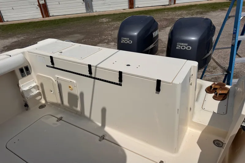 Slide: The Image of 2004 Pursuit 2670 Cuddy Console boat with Yamaha 200 engines in storage. - 9