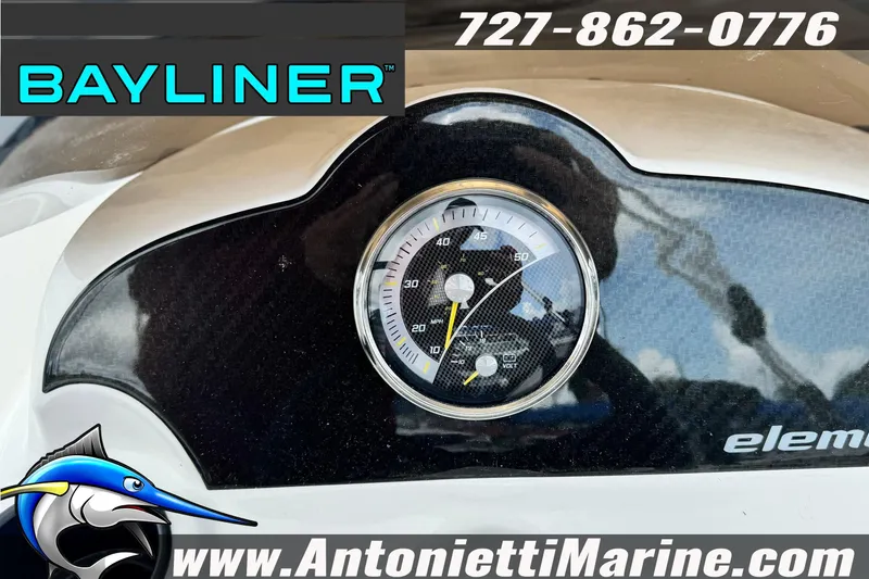 Slide: The Image of Bayliner Element E16 dashboard with gauge, logo, and contact details. - 13
