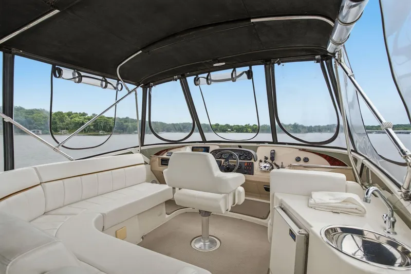 Slide: The Image of Interior of 2005 Carver 39 Motor Yacht with helm, seating, and panoramic windows. - 16