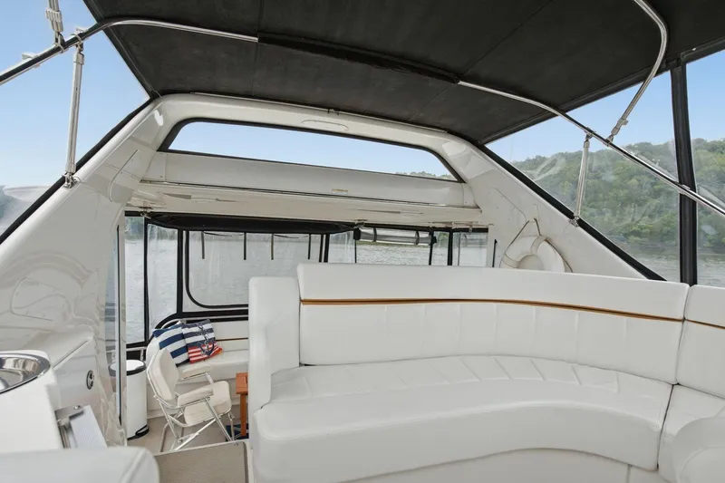 Slide: The Image of 2005 Carver 39 Motor Yacht interior with white seating and scenic water view. - 19