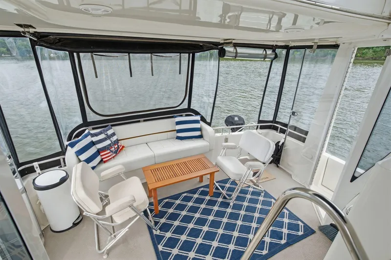 Slide: The Image of Luxurious 2005 Carver 39 Motor Yacht interior with seating, table, and lake view. - 20