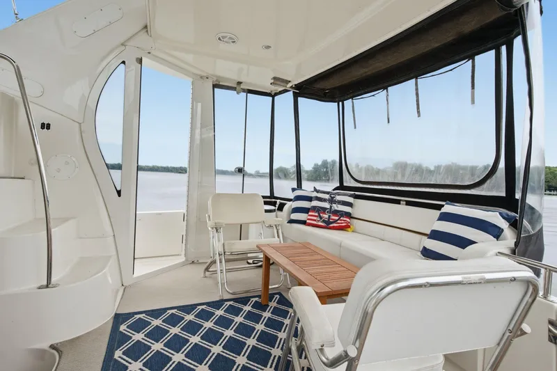 Slide: The Image of 2005 Carver 39 Motor Yacht interior with seating, nautical decor, and river view. - 21