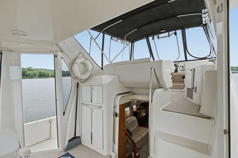 Slide: The Image of 2005 Carver 39 Motor Yacht interior with helm, seating, and water view. - 23