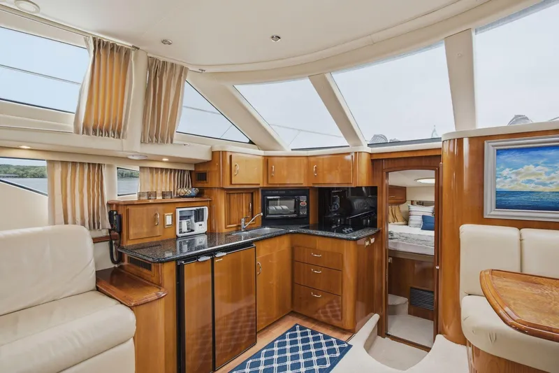 Slide: The Image of Luxurious interior of 2005 Carver 39 Motor Yacht with modern kitchen and seating area. - 28