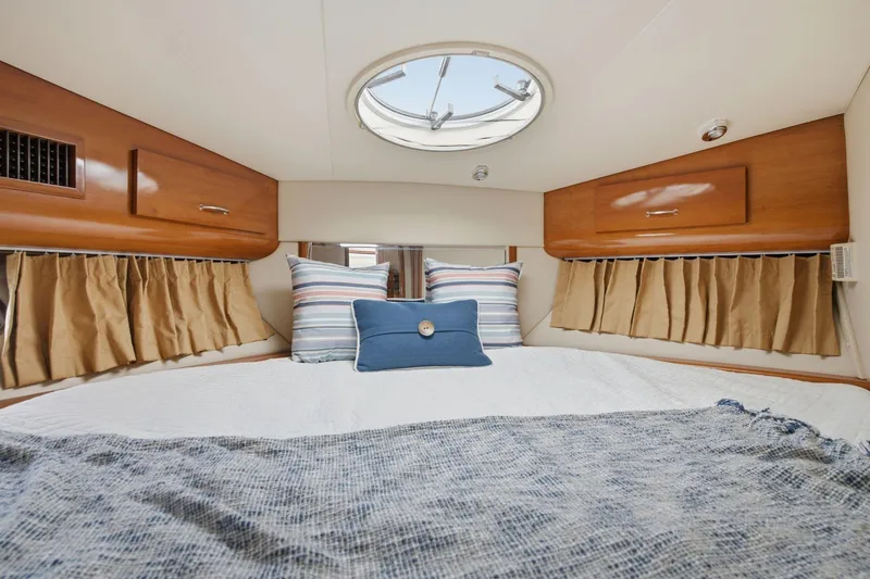 Slide: The Image of Cozy bedroom interior of 2005 Carver 39 Motor Yacht with skylight and striped pillows. - 33