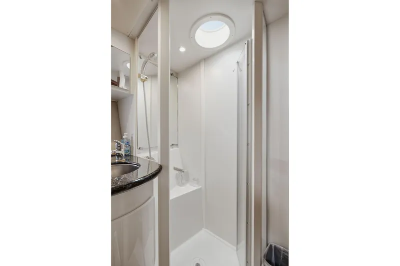 Slide: The Image of 2005 Carver 39 Motor Yacht bathroom with shower, sink, and circular skylight. - 36