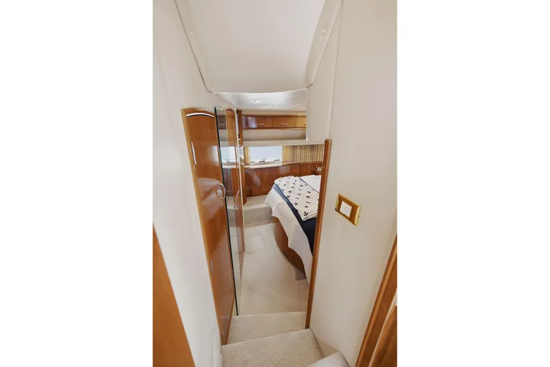 Slide: The Image of Interior of 2005 Carver 39 Motor Yacht showing bedroom with nautical-themed bedding. - 38