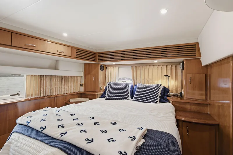 Slide: The Image of Luxurious bedroom interior of 2005 Carver 39 Motor Yacht with nautical-themed decor. - 39