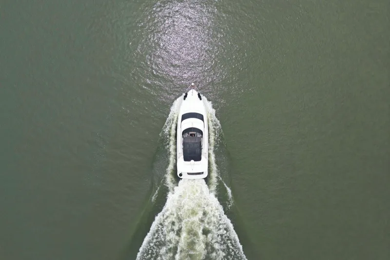 Slide: The Image of Aerial view of 2005 Carver 39 Motor Yacht cruising on open water. - 4