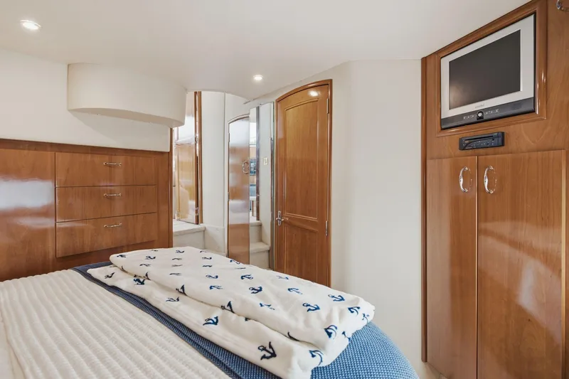 Slide: The Image of Luxurious cabin interior of 2005 Carver 39 Motor Yacht with wood finishes and TV. - 40
