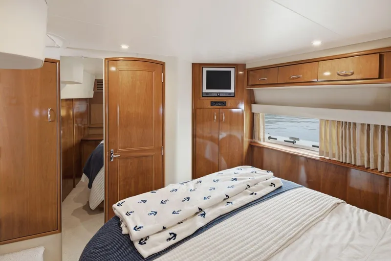 Slide: The Image of Luxurious cabin interior of 2005 Carver 39 Motor Yacht with wood finishes and cozy bedding. - 41