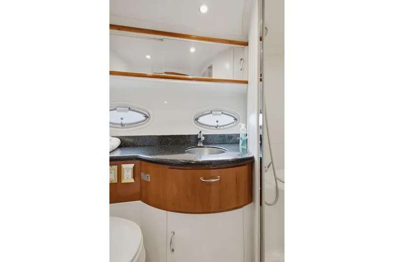 Slide: The Image of Luxurious bathroom interior of 2005 Carver 39 Motor Yacht with sleek sink and porthole windows. - 44