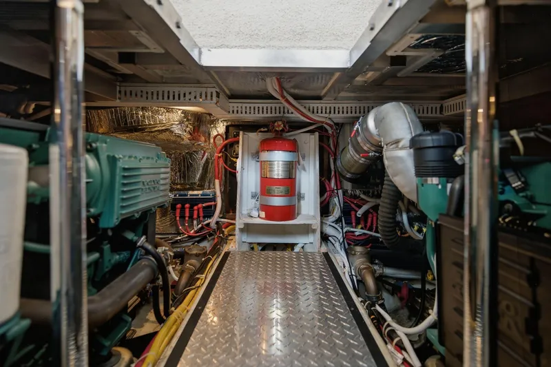 Slide: The Image of Engine room of 2005 Carver 39 Motor Yacht with visible machinery and fire extinguisher. - 45