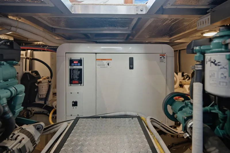Slide: The Image of Engine room of 2005 Carver 39 Motor Yacht with generator and mechanical components. - 55