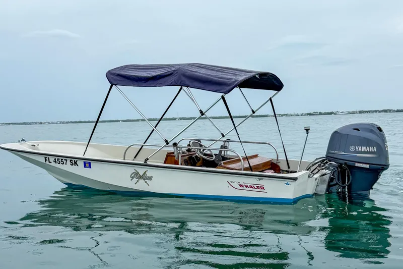 The Image of 1983 Boston Whaler 15 boat with Yamaha motor on calm water. - 0