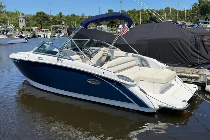 The Image of 2020 Cobalt R3 boat docked in a marina, featuring sleek design and blue exterior. - 0