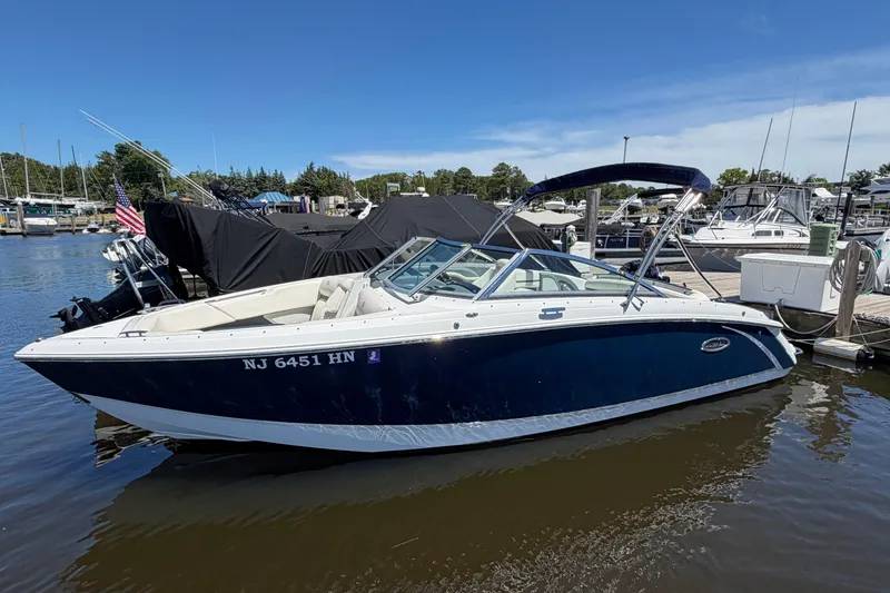 Slide: The Image of 2020 Cobalt R3 boat docked at marina under clear blue sky. - 1