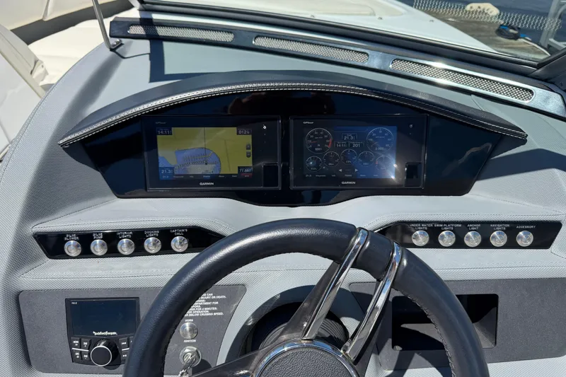Slide: The Image of 2020 Cobalt R3 boat dashboard with Garmin navigation displays and control buttons. - 13