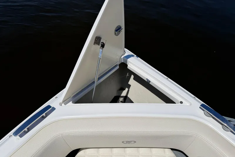Slide: The Image of Open storage compartment on 2020 Cobalt R3 boat, featuring white cushioned seating. - 2