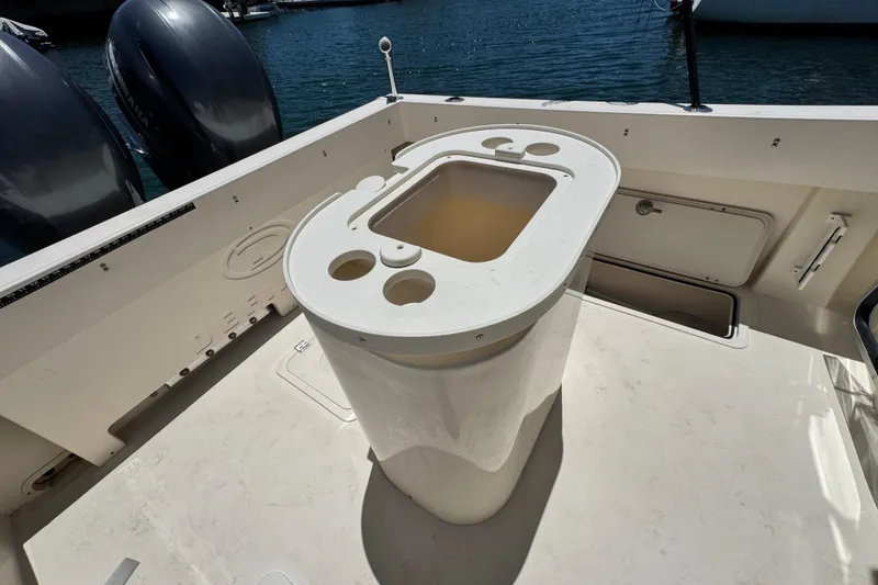 Slide: The Image of 2016 Defiance San Juan 250 boat deck with storage and dual engines. - 16