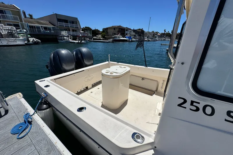 Slide: The Image of 2016 Defiance San Juan 250 boat docked in a marina, featuring dual engines. - 18