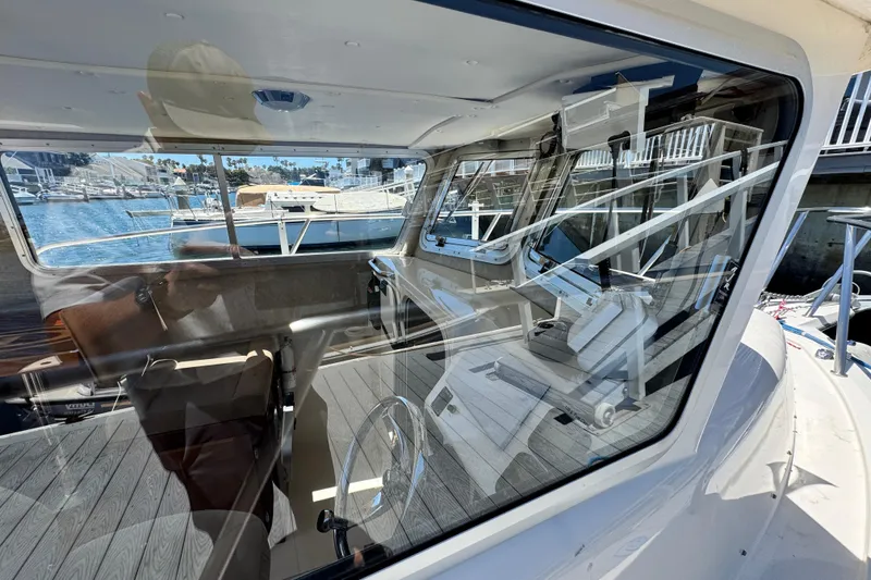 Slide: The Image of Interior view of 2016 Defiance San Juan 250 boat through window, dockside. - 19
